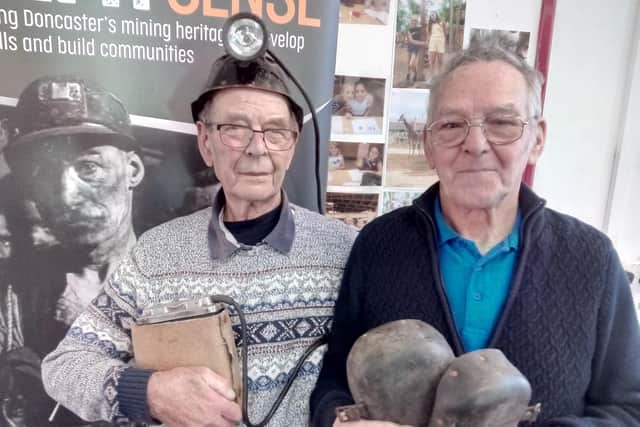 Former Brodsworth and Bullcroft miner Thomas Metcalf, aged 86, of Scawsby, with a miners lamp battery, and former Rossington and Brodsworth miner Ernie Plastow, aged 81, of Woodlands, with a pair of miners' knee pads.