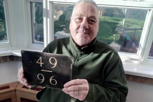 Andy Waterworth, aged 55, of Adwick, with a colliery locker bays sign. Any was a miner at Brodsworth and Bentley pits