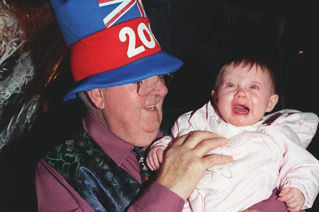Old year out New Year in.. old and young residents hail the new year at  Sycamore Grove, Cantley, Doncaster at their Millennium street party. Pictured are  John Custons (78) and Emily Stacey (6 months)