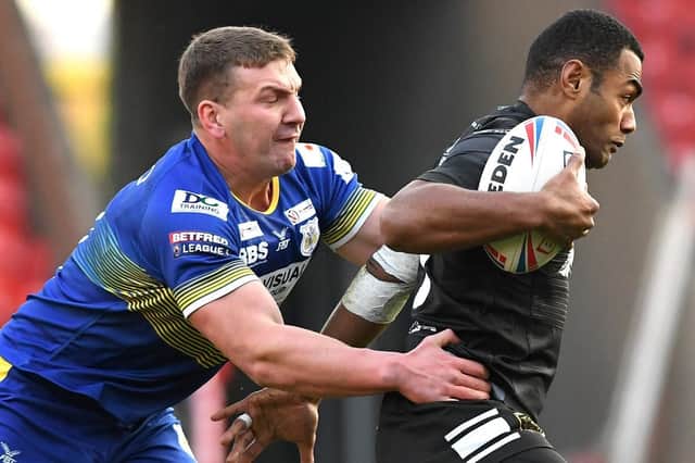 Dons' Russ Spiers gets to grips with Hull's Ratu Naulago.