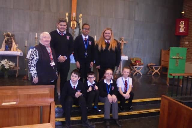 Bobby Roberts with pupils in church
