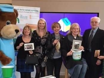Fundraiser Helen Gallagher (third from right) with supporters waits to have her locks shorn