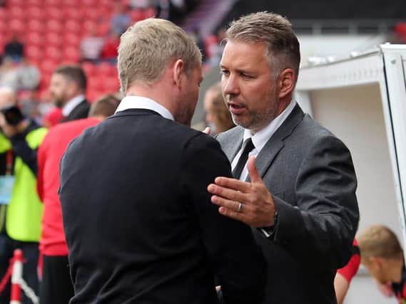 Darren Ferguson shakes hands with Grant McCann at the Keepmoat in September 2017 when they were in charge of the opposite clubs to the ones they will manage this weekend