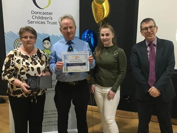 Foster carers Janet and Stuart Roberts receive an Outstanding Contribution to Fostering award at the Doncaster Childrens Services Trust Star Awards celebrations. They were presented by Trust Young Advisor Caitlin and Trust chairman, Tony Hunter