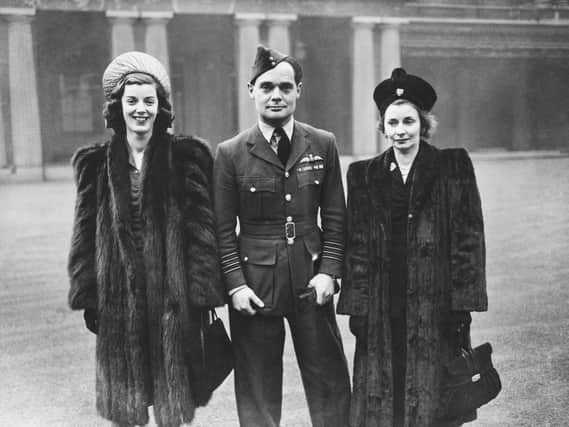 RAF fighter ace Douglas Bader (1910 - 1982) leaves Buckingham Palace after receiving new bars to his DSO and DFC, 27th November 1945. Accompanying him are his wife Thelma (right) and Thelma's sister Jill Addison. Bader lost both legs during an aerobatic stunt in 1931, but his skills as a pilot were unaffected. (Photo by Keystone/Hulton Archive/Getty Images)