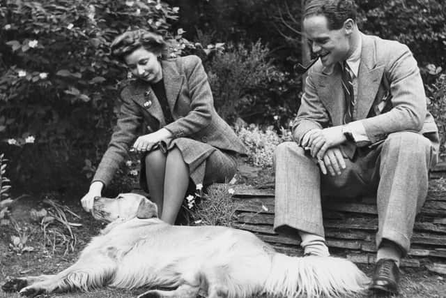 RAF flying ace Group Captain Douglas Bader (1910 - 1982) in the garden of his home in Ascot, Berkshire, with his wife Thelma and Golden Retriever Shaun, after his release from a German prisoner-of-war camp, World War II, 1945. (Photo by Keystone Features/Hulton Archive/Getty Images)