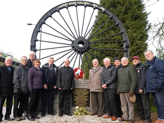 Members of Cadeby Main Colliery Memorial Group, pictured by the Pit Wheel memorial. Picture: NDFP-05-02-19-CadebyColliery-1