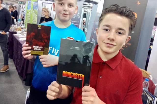 Alex Emsley, 13, ad Tom Morrell, 14, from  XP School, show off the school's books at the Doncaster Business Showcase