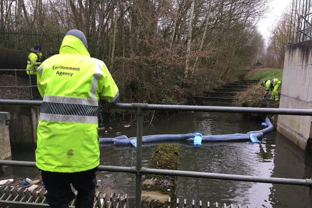 Environment Agency officers at the site of an oil slick in a stream called the mother drain, which goes through Potteric Carr nature reserve, Doncaster, before joining the Rover Torne