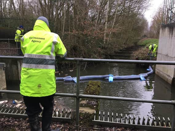Environment Agency officers at the site of an oil slick in a stream called the mother drain,  which goes through Potteric Carr nature reserve, Doncaster, before joining the Rover Torne