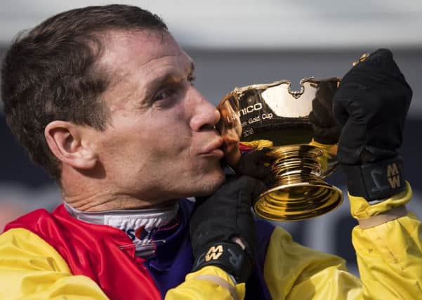 Champion jockey Richard Johnson kisses the Cheltenham Gold Cup after victory on Native River at last year's Festival. (PHOTO BY: Justin Setterfield/Getty Images)