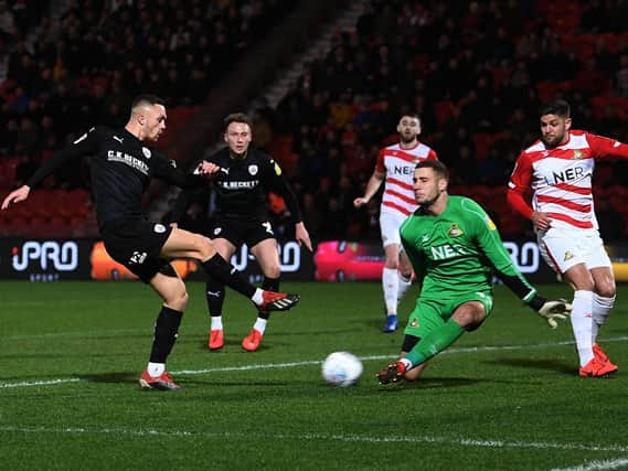 Doncaster's Marko Marosi races out to stop Barnsley's Jordan Williams