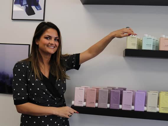 Gemma Thomas, the manager, with Kevin Murphy products.