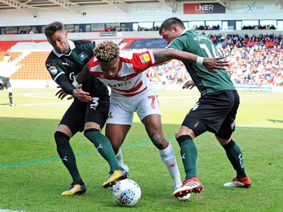 Mallik Wilks gets close attention during the win over Peterborough United
