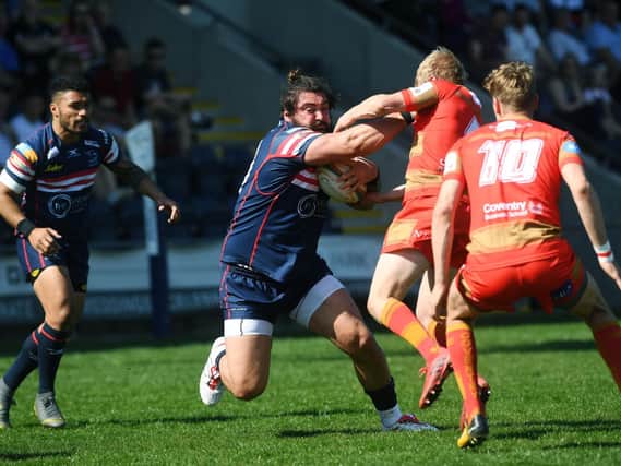 Rory Pitman is tackled by Coventry's Pete White.