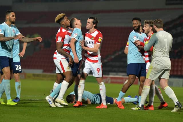 Tempers flare after Ross Sykes suffers a high kick from Kieran Sadlier.
Doncaster Rovers v Acrington Stanley.  Keepmoat Stadium.  SkyBet League 1.
23 April 2019.
Picture Bruce Rollinson