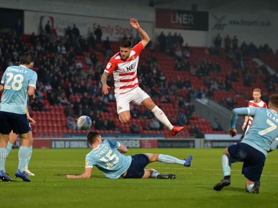 Danny Andrew is forced to leap over a challenge during the defeat to Accrington