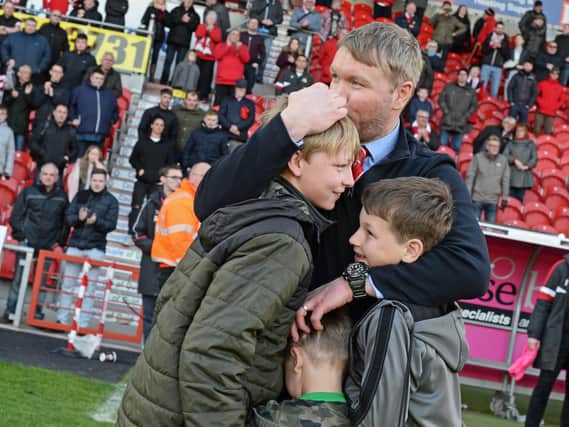 Grant McCann celebrates with his family after Rovers sealed their place in the League One play-offs. Photo: Marie Caley