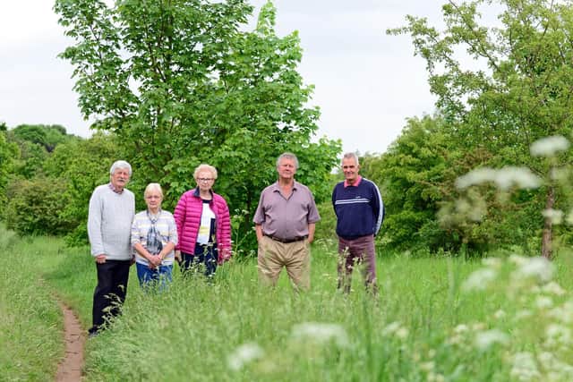 Rose Hill Rise Residents Association committee members l-r Patrick Fielding, Wendy Wright, Secretary, Diana Hoyle, Treasurer,  Dick Farthing, Chairman and  Larry Grove,  pictured on the land in question. Picture: Marie Caley