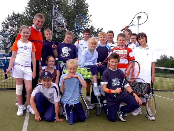 Tennis coach John Willis (left) and  Doncaster Lawn tennis Club chair Miles Collett with  youngsters who at a summer tennis camp.