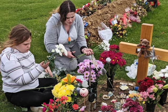 Taylor's sisters Myah and Angelica, pictured by his grave. Picture: NDFP-02-07-19-Matthews-8