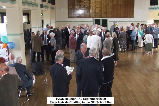 Former pupils chat at a reunion in the former school hall