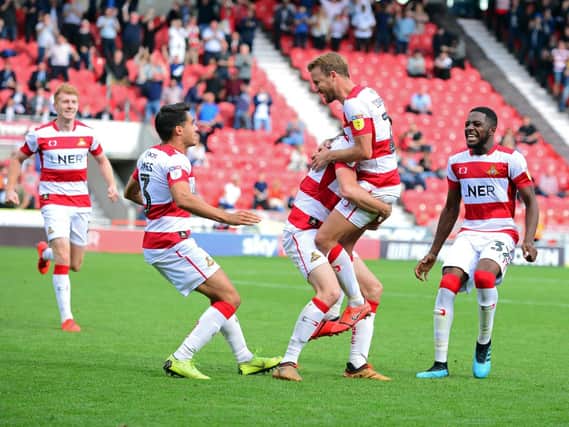 James Coppinger celebrates with team mates as Rovers find the winning goal in stoppage time against Fleetwood Town