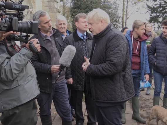 Boris Johnson speaks to the press on a visit to flood-hit parts of Yorkshire. Photo: PA
