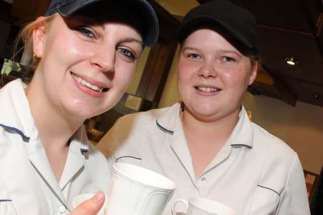 Sarah Shaw and Jodie Churm, of Holmes and Gardens. Epworth with a cup of coffee, which is on offer. Picture: Andrew Roe
