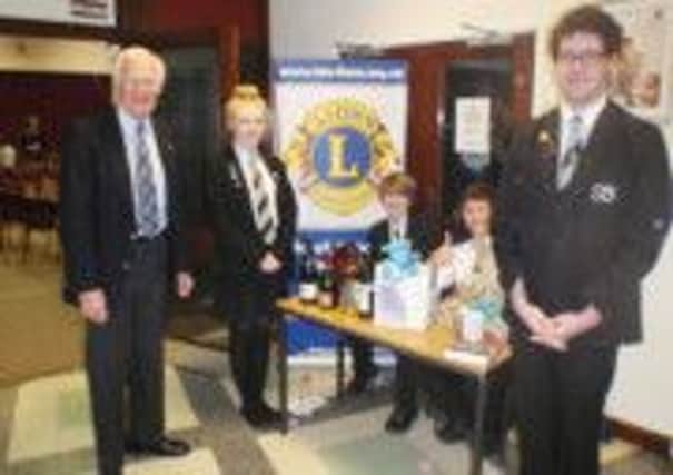 South Axholme Academy and the Axholme Academy staged a joint concert recently, supported by the Isle of Axholme Lions Club - pictured is  Peter Lindley, Isle of Axholme Lions President, with the Head Girl and Head Boy of South Axholme Academy at the raffle stall.