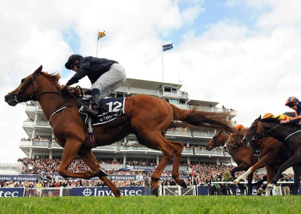 WORLD BEATER -- Aidan O'Brien's Ruler Of The World flashes past the post to win last year's Investec Derby at Epsom (PHOTO BY: Andrew Matthews/PA Wire).