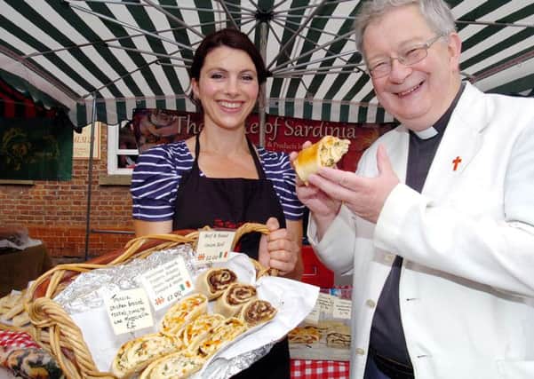 Epworth Food Fair.  Rev Ian Walker from St Andrews Church tastes the goods on the Taste of Sardinia stall helped by Clare Eastwood (36).  Picture: Malcolm Billingham