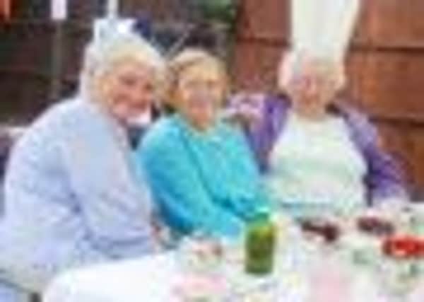 Pictured (L-R) are Anne Lee, Connor McGlashen and Brenda Marsden enjoying their Strawberry Tea in the Vicarage Garden.