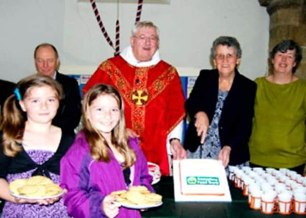 Pictured are Rev David Henson with Jean Coulson and Carol Freeman of the Food Bank, and (front) Lexxie and Madison Sawyer, who had made cookies for the service.