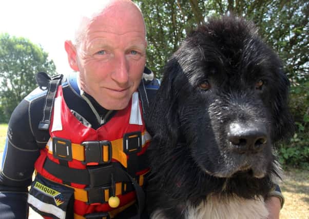 Emergency Services Rescue Day at 7 Lakes Country Park in Ealand. Pete Lewin with his rescue dog.