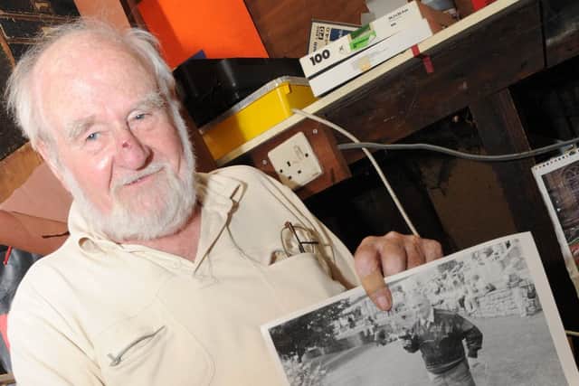 Harry Snow, of Haxey looks at old photographs of the area he has. Picture: Andrew Roe