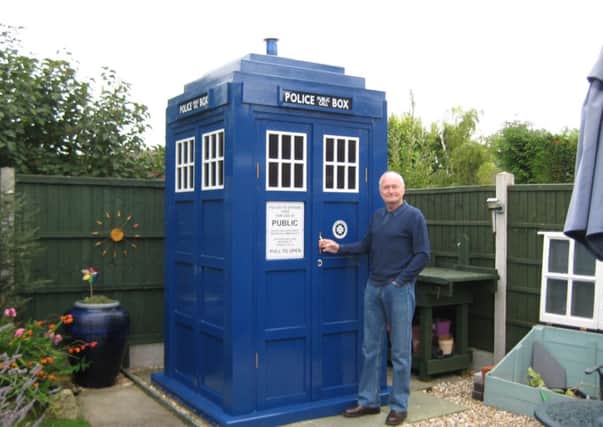 Roy Scaife admires his handiwork of the Tardis shed he built fo his wife Kathryn.