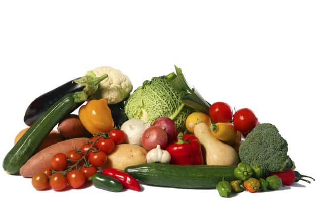 A big display of healthy vegetables isolated on white, including savoy cabbage, cauliflower, vine tomatoes, flow tomatoes, broccoli, green courgette, yellow courgette, jalapeno peppers, leeks, sweet potato, potato, aubergine or eggplant, garlic, red and white onions, butternut squash gourd and miniature peppers.