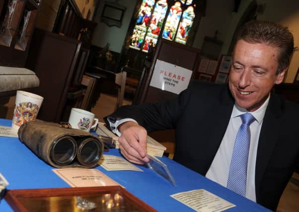 Cllr David Robinson looks at world war one memoriablia at an exhibition at St Andrew's Church, Epworth. Picture: Andrew Roe
