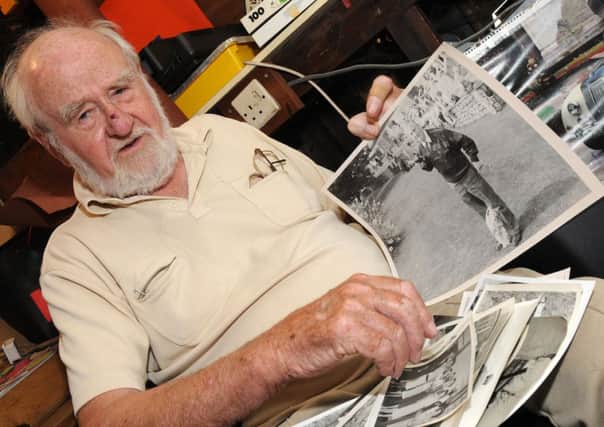 Harry Snow, of Haxey looks at old photographs of the area he has. Picture: Andrew Roe