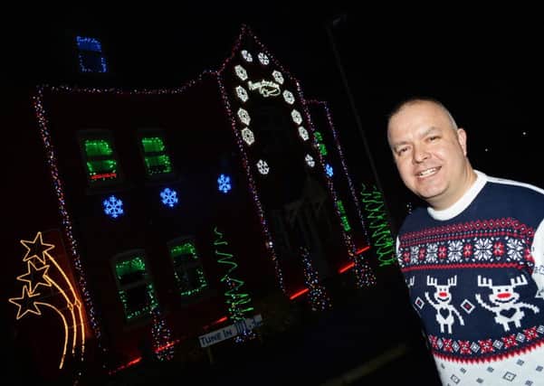 Rob Brown, of Crowle, is raising money for the Lindsey Lodge Hospice with his Christmas Lights display. Picture: Marie Caley NEPB 04-12-14 Brown MC 1