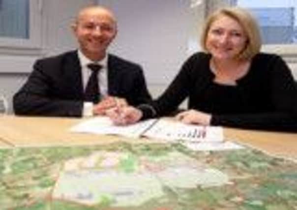 Steve Gill and Karen Switzer sign the deal between Robin Hood and TUI.