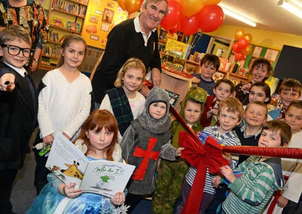 Author Gervase Phinn pictured officially opening Westwoodside C of E primary schools new library. Picture: Marie Caley NEPB 12-12-14 Library MC 1