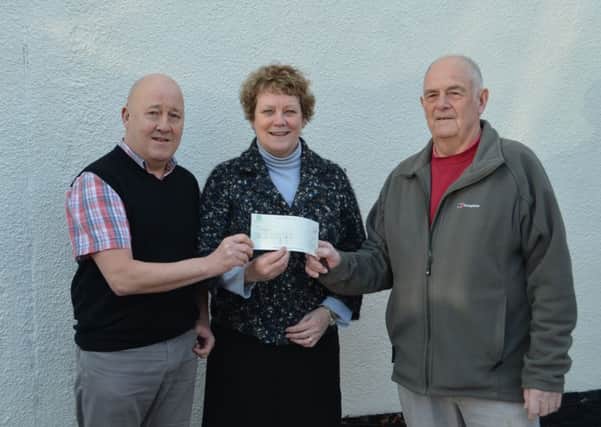 Sid and Sylvia Burgess of Misterton have raised £220 for two local good causes and hand a cheque to coordinator of tghe Five Villages First Responders Martyn Johnson.