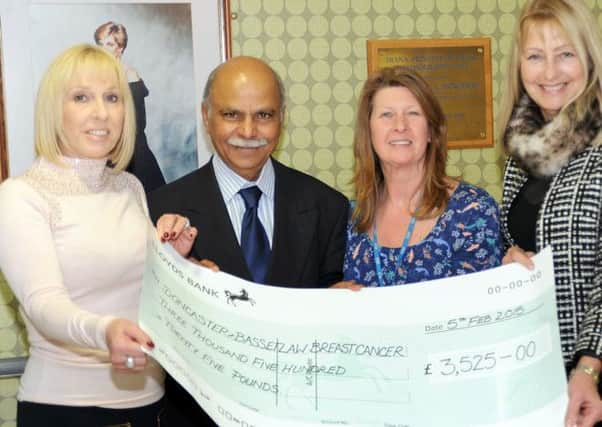 Event organisers, Anita Glasby, left, and Sue Withers, right, hand over the proceeds of their Ladies Luncheon at the Crown Hotel in Bawtry, totalling £3,525 to breast cancer surgeon Mr. Kadappa Kolar and his secretary Julie Primdore at the Bassetlaw Hospital.