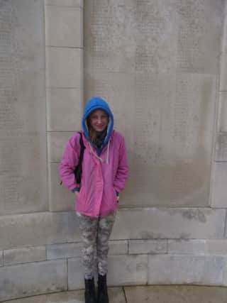 Paying her respects to her great uncle, Ezra Haslam at Tyne Cot is Axholme Academy student Sophie Haslam.