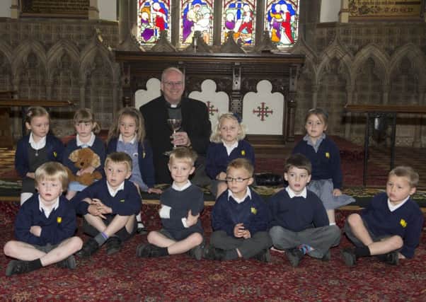 Rev Jeremy Green shows reception puils from Westwoodside School around St Nicholas Church at Haxey