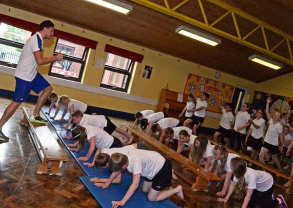 Former Olympic swimmer James Kirton puts Westwoodside C of E primary school children through their paces. Picture: Marie Caley NEPB 08-06-15 Olympic MC 5