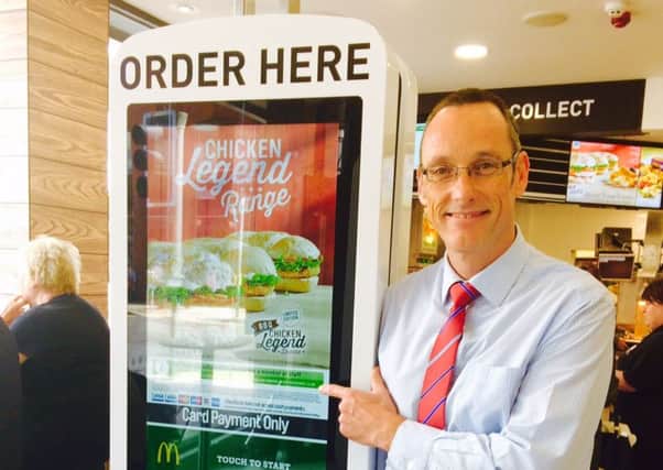 McDonald's franchisee Mark Clapham shows off the new high tech ordering point.