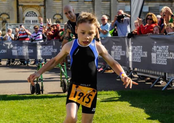 Bailey Matthews  8 from Doncaster crosses the finish line  to complete his first ever triathlon at Castle Howard on sat.